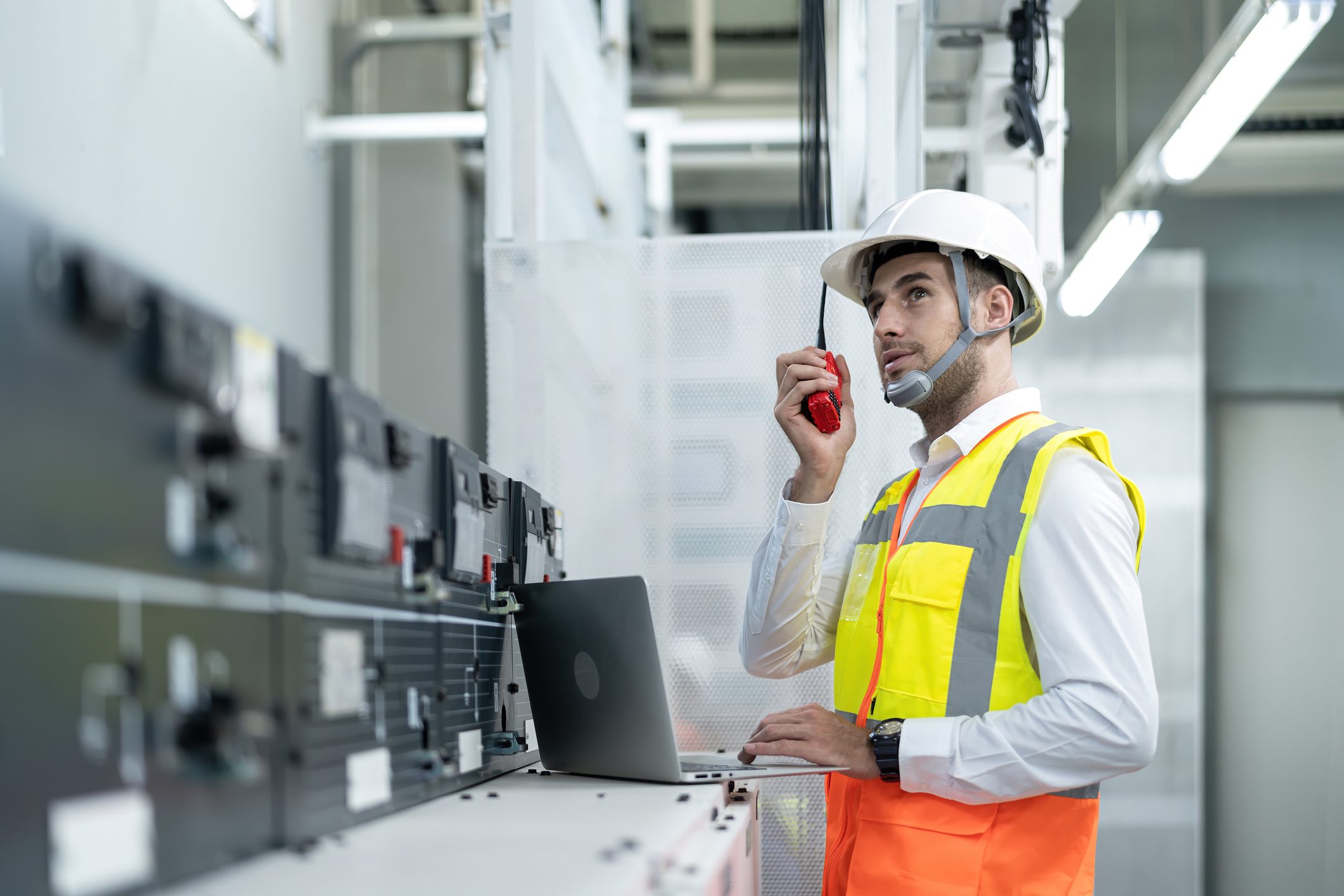Young Electrical Engineer Working at Control Room